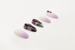 a set of Ardell Nail Addict Premium Artificial Nail in Marble Purple Ombré in almond shape laid down  in 45 degree angle