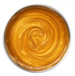 Fully melted WAX BEADS GOLDEN ALL PURPOSE FORMULA in wax well displaying a lush, glistening swirl of honey gold hues